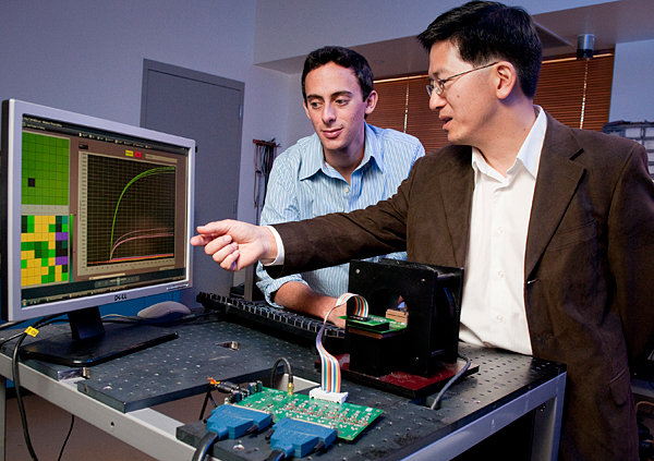 Shan Wang, professor of materials science and engineering and of electrical engineering, and graduate student Richard Gaster 