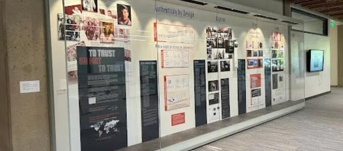 Green library visual display titled 'To Trust or Not to Trust: Authenticity by Design'